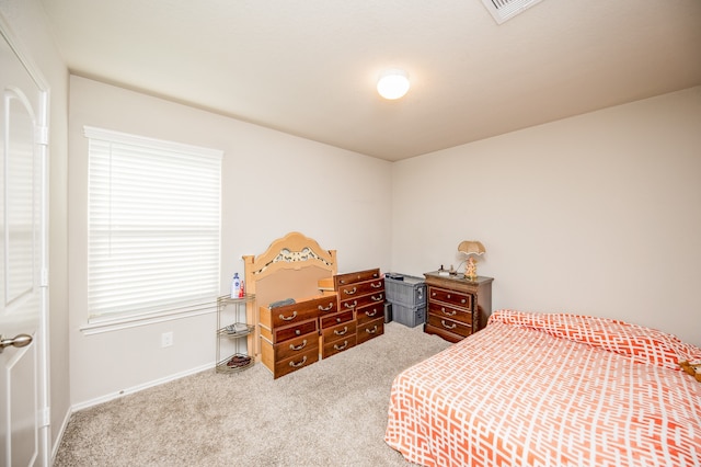 bedroom with carpet floors and multiple windows