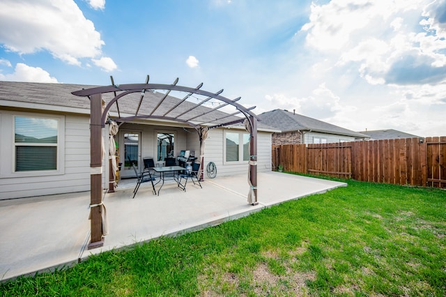 rear view of house with a yard, a pergola, and a patio