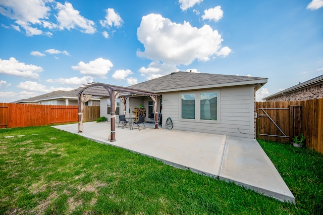 back of property with a lawn, a pergola, and a patio