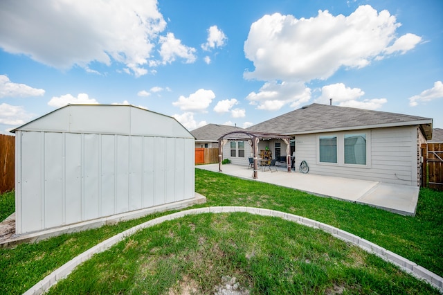 back of property with a lawn and a patio area