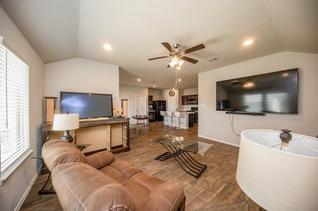 living room with lofted ceiling, dark hardwood / wood-style floors, and ceiling fan