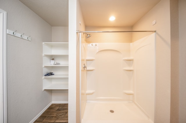 bathroom with walk in shower and wood-type flooring