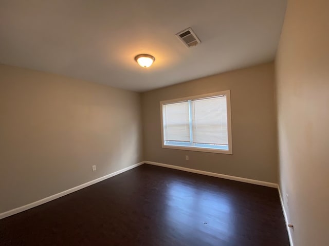 unfurnished room featuring dark wood-type flooring