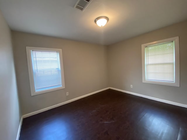 empty room with dark wood-type flooring