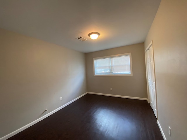 empty room with dark hardwood / wood-style floors