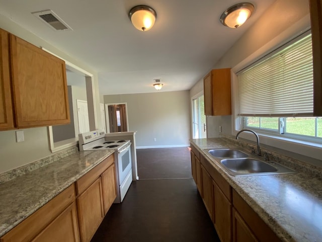 kitchen with electric stove and sink