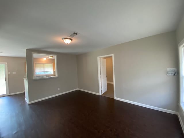 spare room with dark wood-type flooring