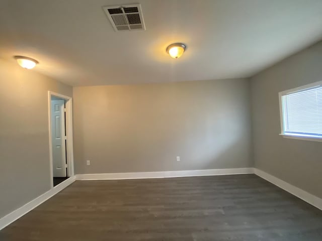 empty room featuring dark hardwood / wood-style flooring