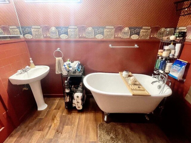 bathroom featuring hardwood / wood-style flooring and a tub