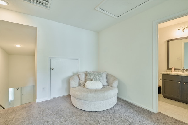 sitting room with sink and light colored carpet