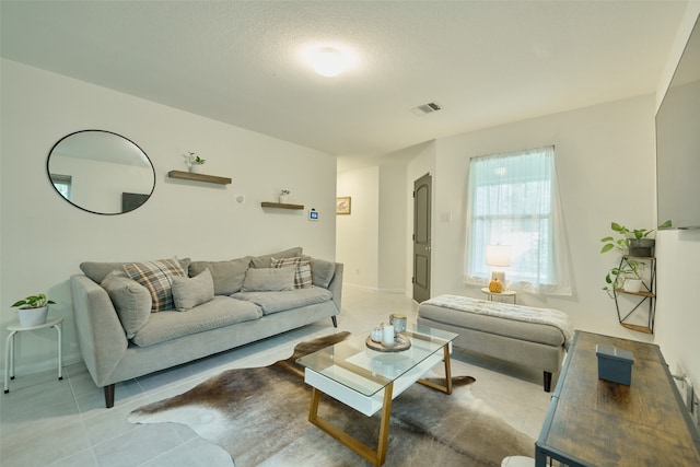 tiled living room with a textured ceiling