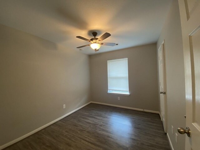 unfurnished room featuring ceiling fan and dark hardwood / wood-style flooring