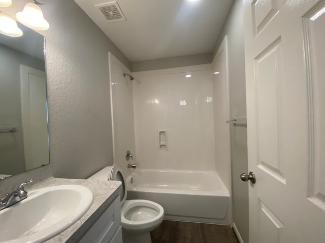 full bathroom with vanity, toilet, bathtub / shower combination, and hardwood / wood-style flooring