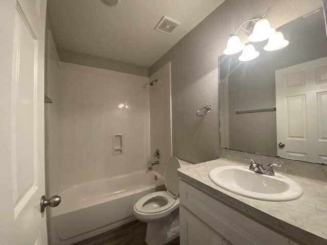 full bathroom with vanity, toilet, bathtub / shower combination, and hardwood / wood-style flooring