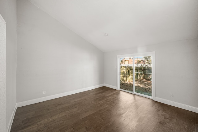 unfurnished room with dark wood-type flooring and vaulted ceiling