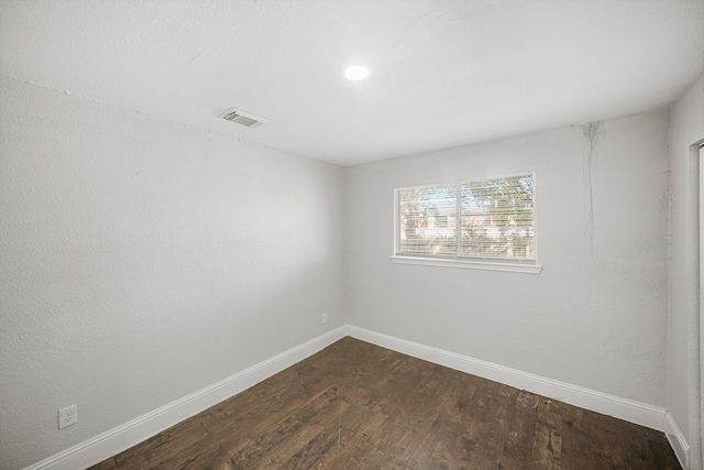 spare room featuring dark hardwood / wood-style flooring