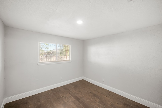 unfurnished room featuring dark hardwood / wood-style floors