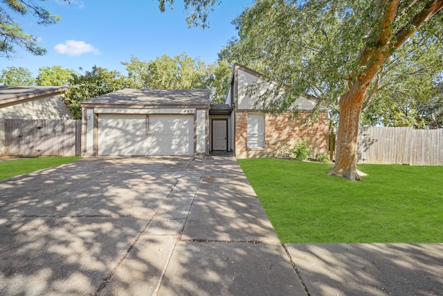 view of front facade with a front yard and a garage