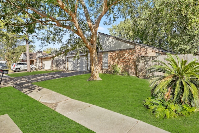 view of front of home with a front yard and a garage