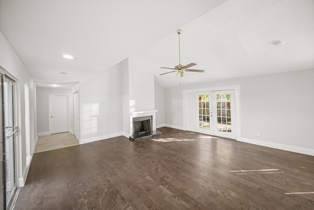 unfurnished living room with french doors, dark hardwood / wood-style floors, vaulted ceiling, and ceiling fan