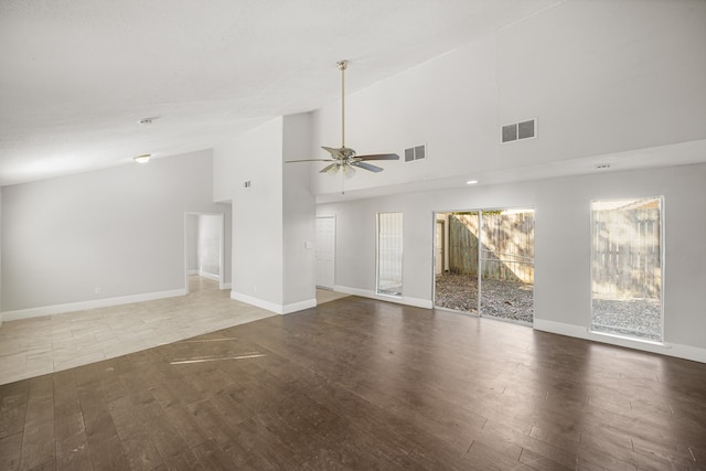 spare room featuring hardwood / wood-style flooring, high vaulted ceiling, and ceiling fan