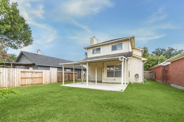 back of property with a patio and a yard