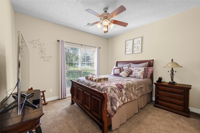 carpeted bedroom with a textured ceiling and ceiling fan