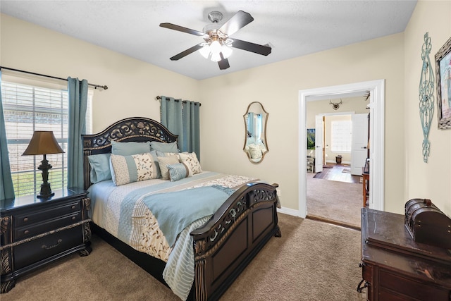 carpeted bedroom with multiple windows and ceiling fan