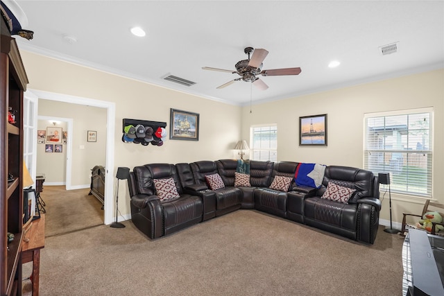 carpeted living room with crown molding and ceiling fan