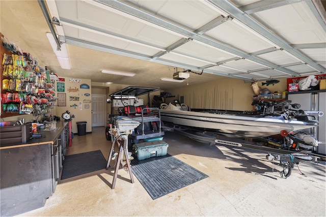 garage with a workshop area and a garage door opener