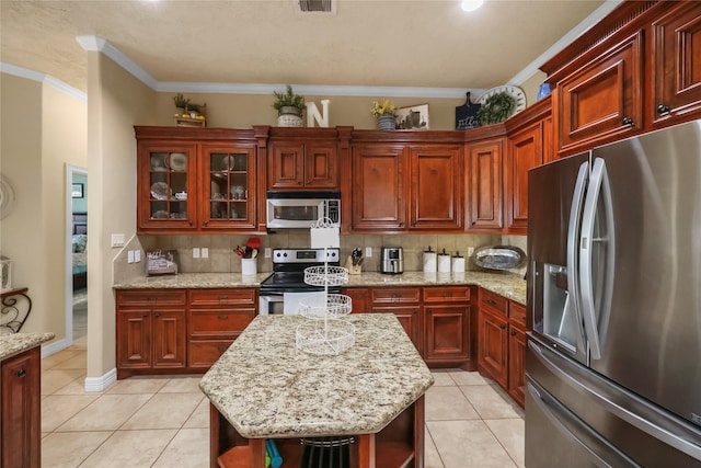 kitchen featuring light stone counters, backsplash, appliances with stainless steel finishes, light tile patterned floors, and ornamental molding