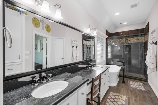 bathroom featuring hardwood / wood-style floors, vanity, lofted ceiling, and shower with separate bathtub