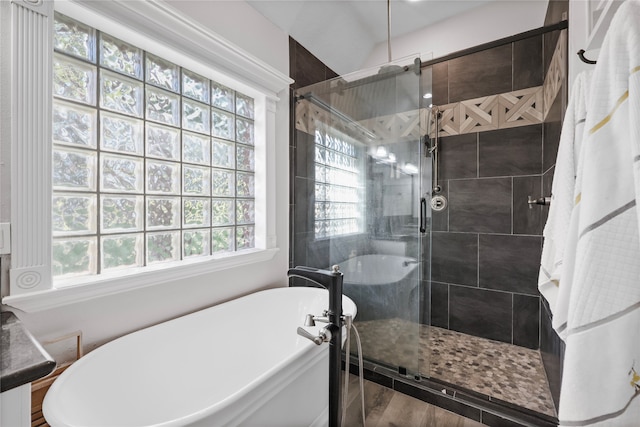 bathroom featuring wood-type flooring and independent shower and bath