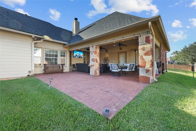 rear view of property featuring a lawn and a patio area