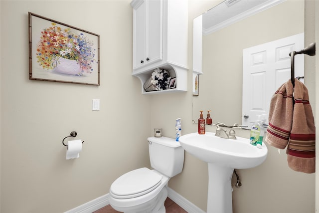 bathroom featuring tile patterned flooring, toilet, and ornamental molding