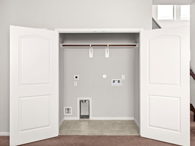 clothes washing area with hookup for a gas dryer, light tile patterned flooring, hookup for an electric dryer, and washer hookup