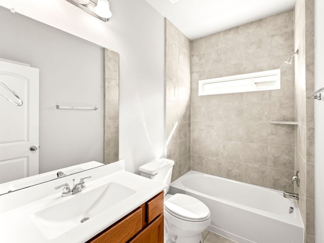 full bathroom featuring tiled shower / bath, vanity, and toilet