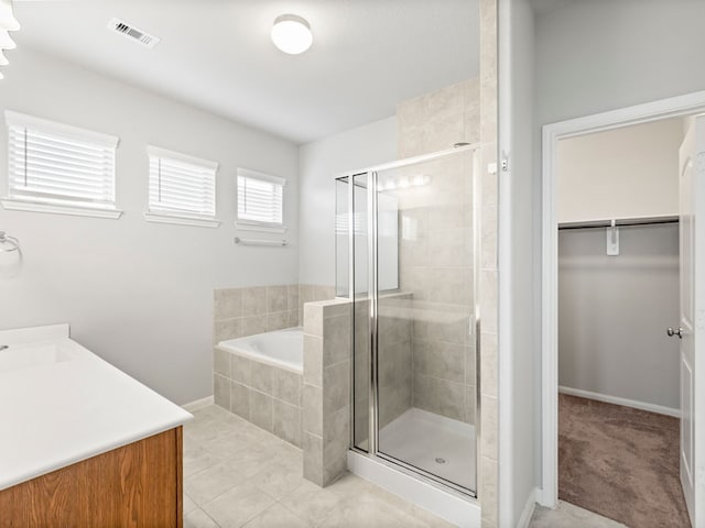 bathroom with vanity, plus walk in shower, and tile patterned floors