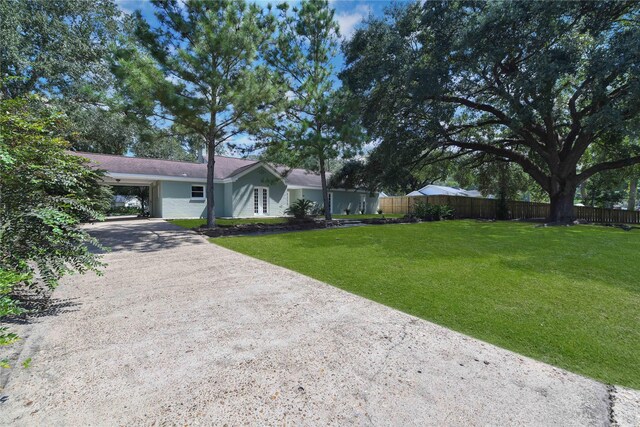 single story home featuring a front lawn