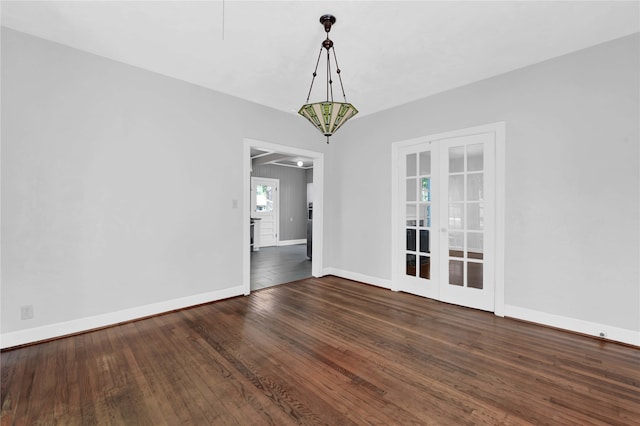 unfurnished dining area with dark hardwood / wood-style floors and french doors