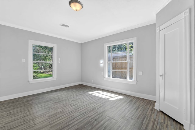 spare room featuring crown molding and dark hardwood / wood-style floors