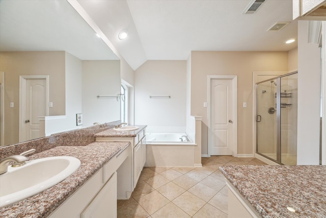 bathroom with independent shower and bath, vaulted ceiling, vanity, and tile patterned flooring