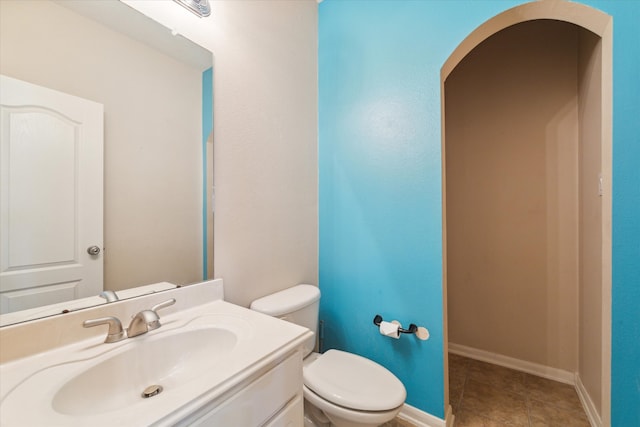 bathroom with vanity, toilet, and tile patterned floors