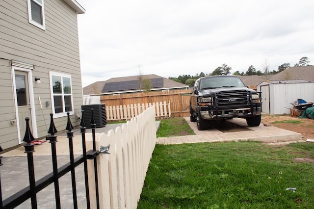 view of yard featuring a shed and a patio