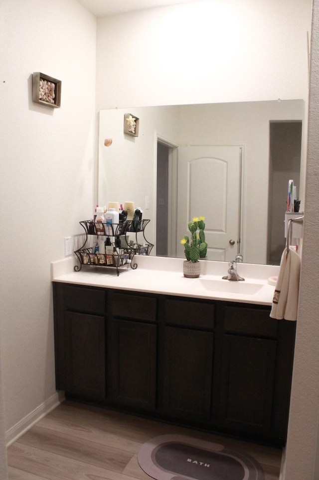 bathroom featuring vanity and hardwood / wood-style flooring