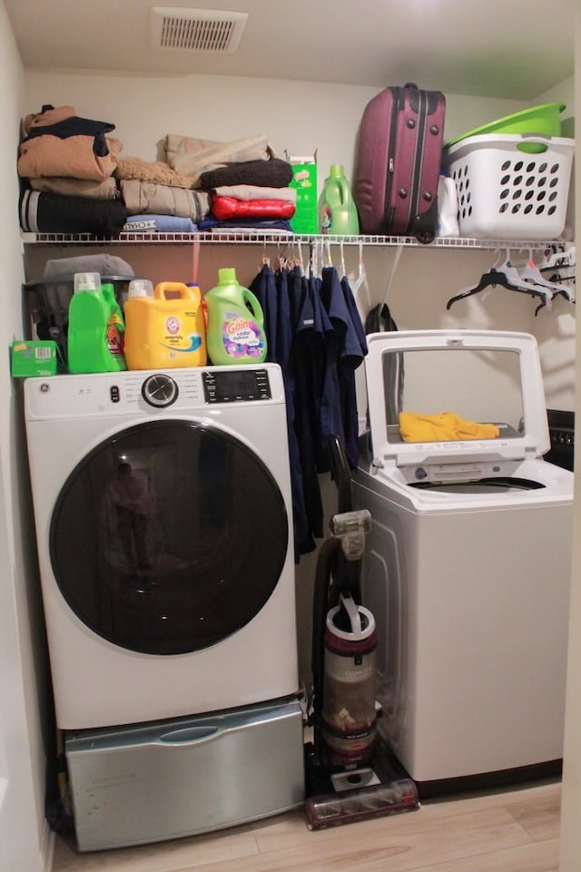 washroom featuring washer / clothes dryer and light hardwood / wood-style floors