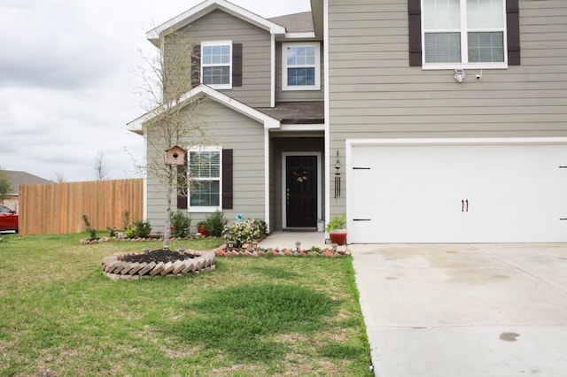 view of front of home featuring a garage and a front yard