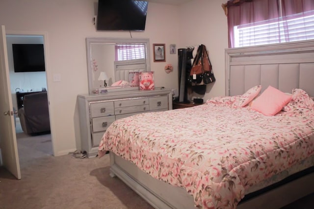 bedroom featuring light carpet and multiple windows