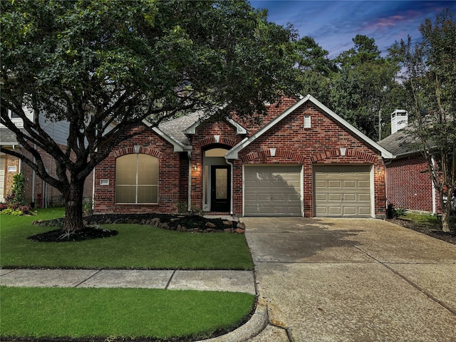 view of front property with a lawn and a garage