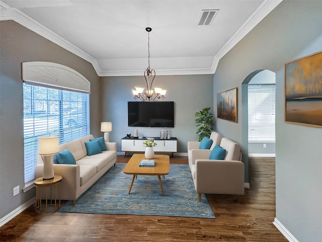 living room featuring ornamental molding, dark hardwood / wood-style floors, and a chandelier